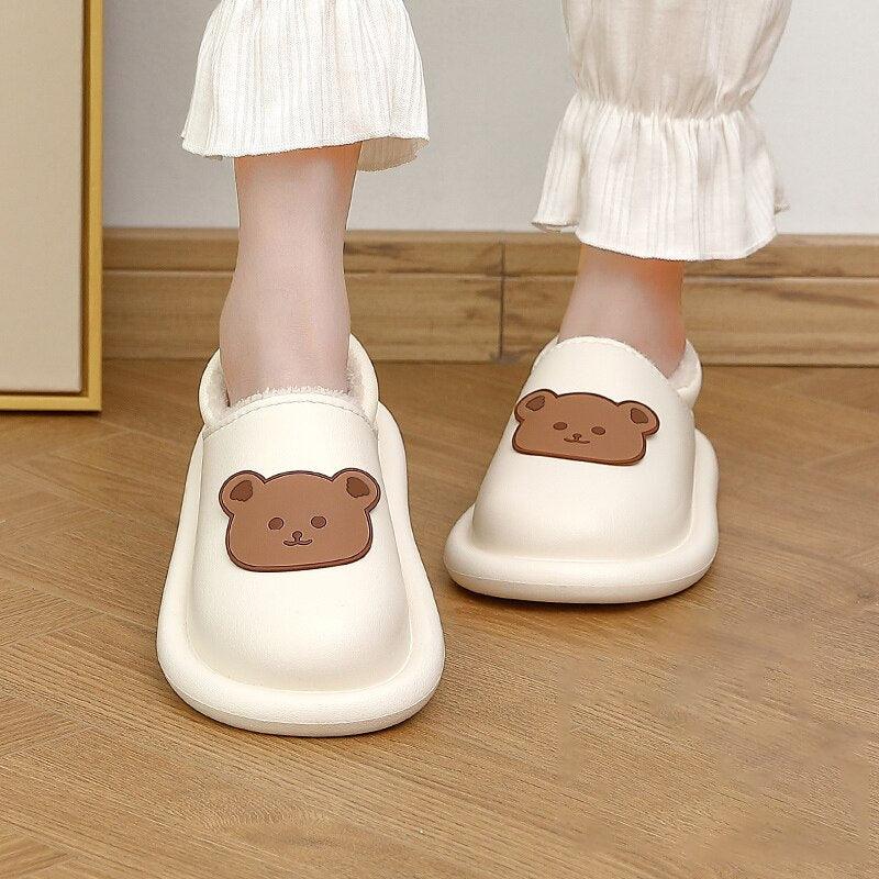 Women's waterproof plush fuzzy clogs in white and dark-blue, featuring a non-slip sole and cozy indoor-outdoor design.