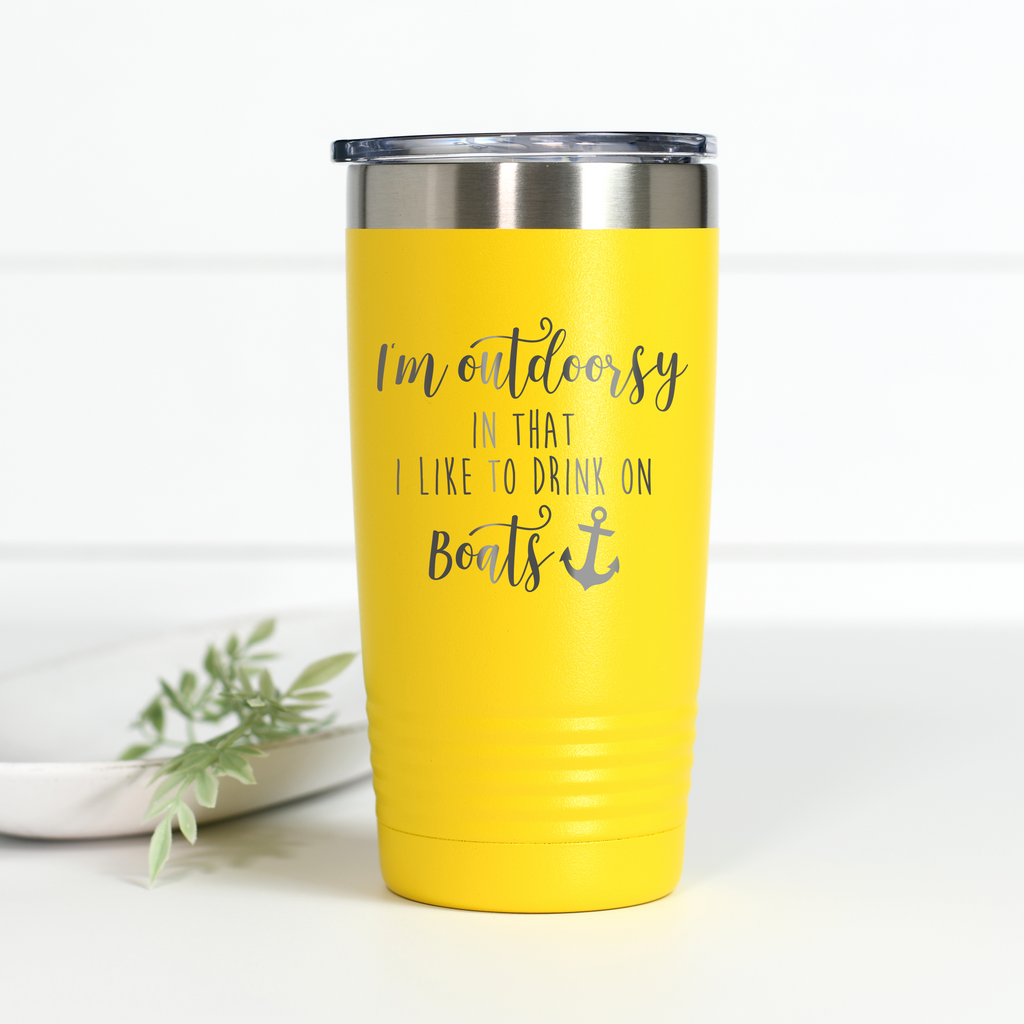 Bright yellow 20 oz stainless steel tumbler with the text I'm outdoorsy in that I like to drink on boats laser engraved on the front.