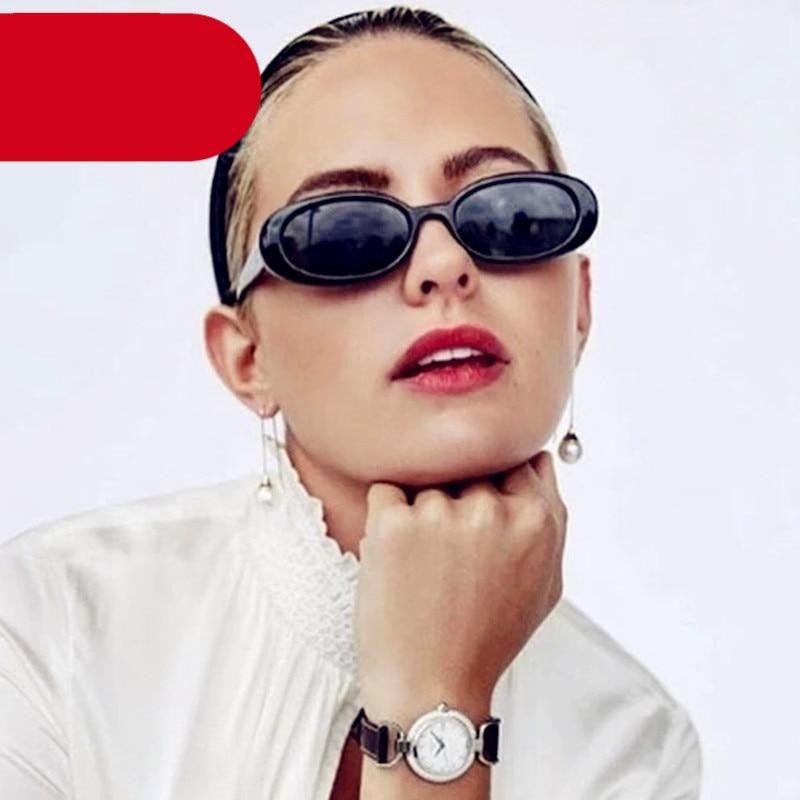 Tiny 90s style retro oval sunglasses with tinted polarized lenses.