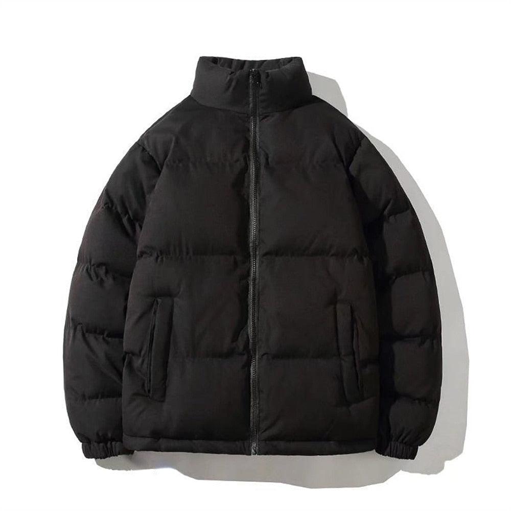 A person wearing a minimalist, oversized unisex winter jacket in a neutral colorway, styled for a streetwear aesthetic.