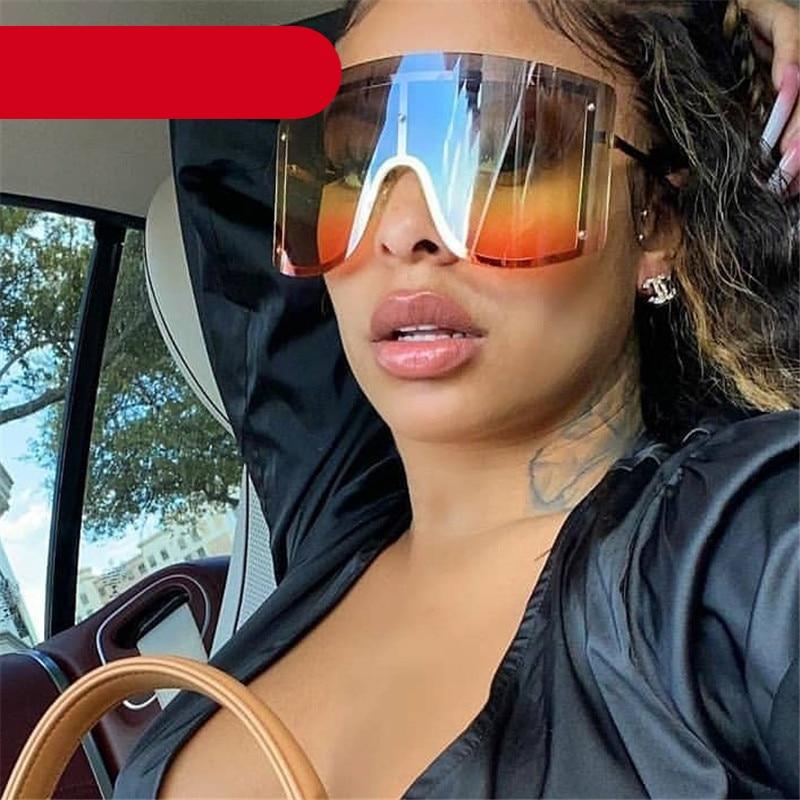 Oversized rimless sunglasses with blue and yellow gradient lenses and a thin metal frame.