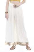 Woman wearing cream wide-leg rayon cotton palazzo pants with a solid minimalist design.