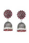 A pair of traditional Kundan Jhumka earrings with rich maroon bead detailing.