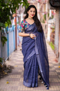 Nblue linen saree with self-weaving checks and a detailed golden pattu border