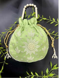 Light green potli bag featuring delicate pearl hand work for ethnic occasions