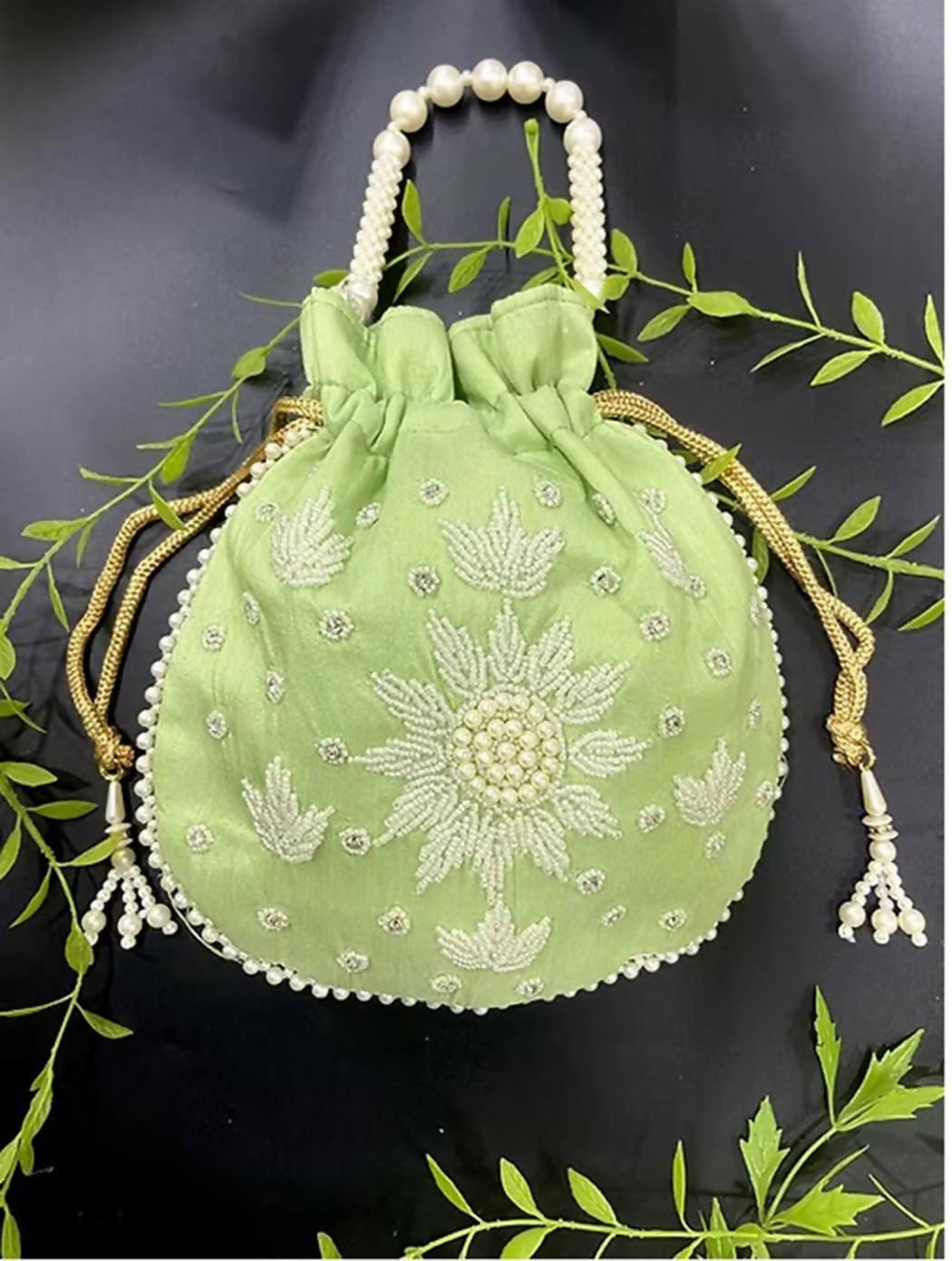 Light green potli bag featuring delicate pearl hand work for ethnic occasions