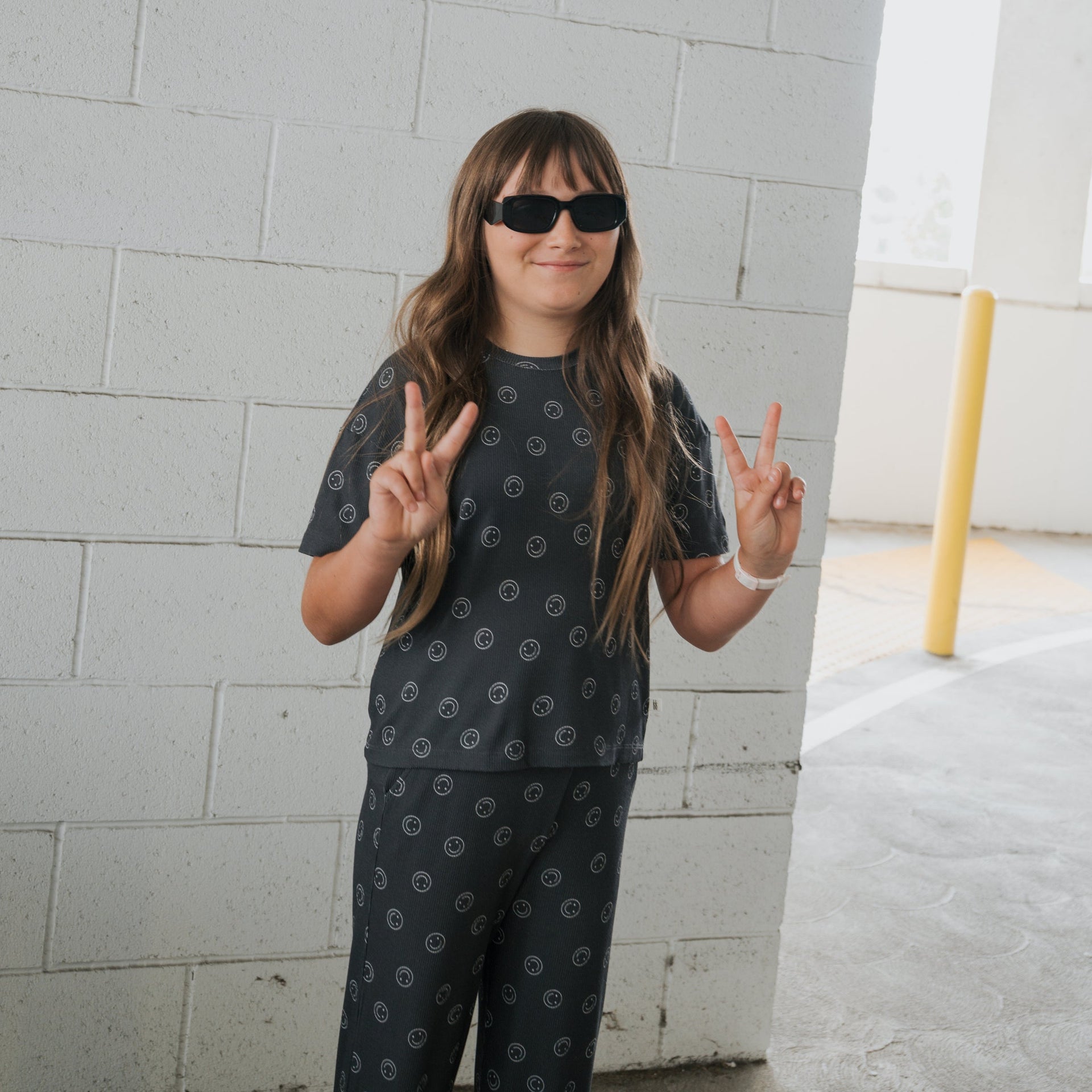 Child wearing a charcoal and white ribbed bamboo lounge set with a boxy top and wide-leg pants.