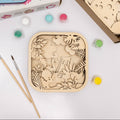 A 3D wooden dinosaur puzzle with paints and brushes for kids' DIY craft projects