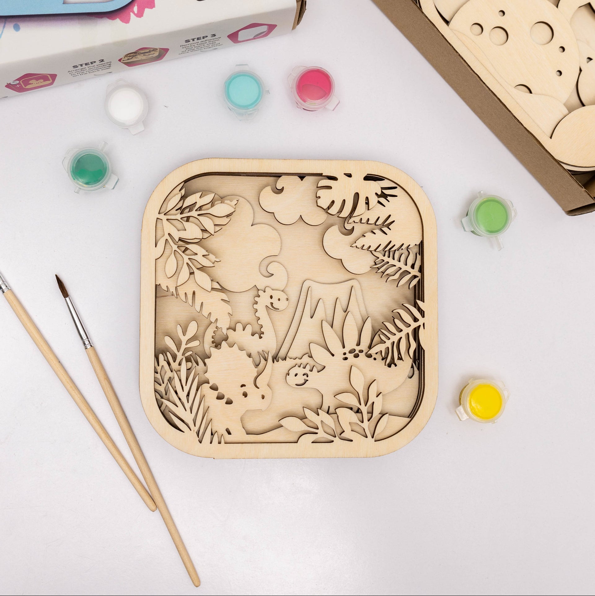 A 3D wooden dinosaur puzzle with paints and brushes for kids' DIY craft projects