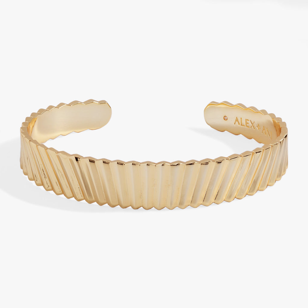 Wide open cuff bracelet with intricate palm frond radiating texture in polished gold tone finish.