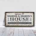 Personalized Grandma and Grandpa house canvas sign displayed on a wall with grandchildren's names