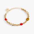 Expandable metal bead bangle featuring Italian-themed charms including a tomato, bowtie pasta, and an olive with a red stone.