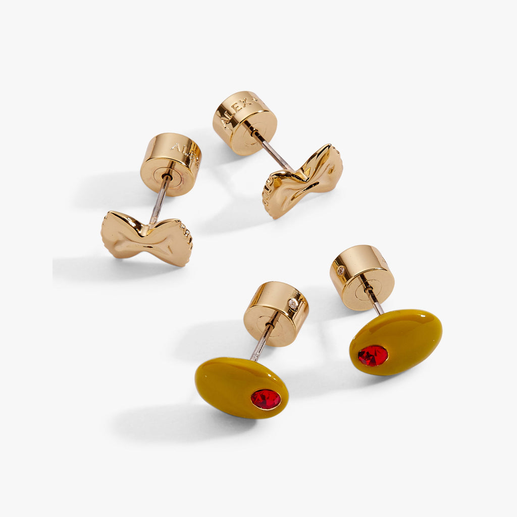 A whimsical pair of gold pasta-themed stud earrings featuring an enamel olive and a gold bowtie pasta design.
