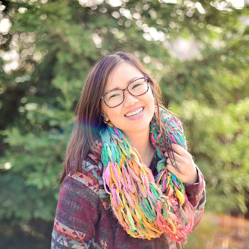 A pastel chiffon cowl scarf created using the arm knitting technique.