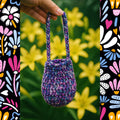 Alpine Mini Bucket Bag crochet project featuring textured Alpine stitches and a drawstring closure.