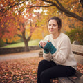 A pair of solid teal fingerless knit mittens with a minimalist design.
