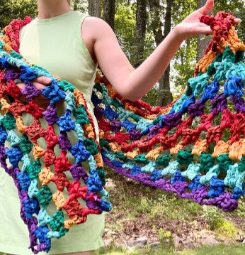 Rainbow checkers crochet shawl with a textured geometric knit pattern.