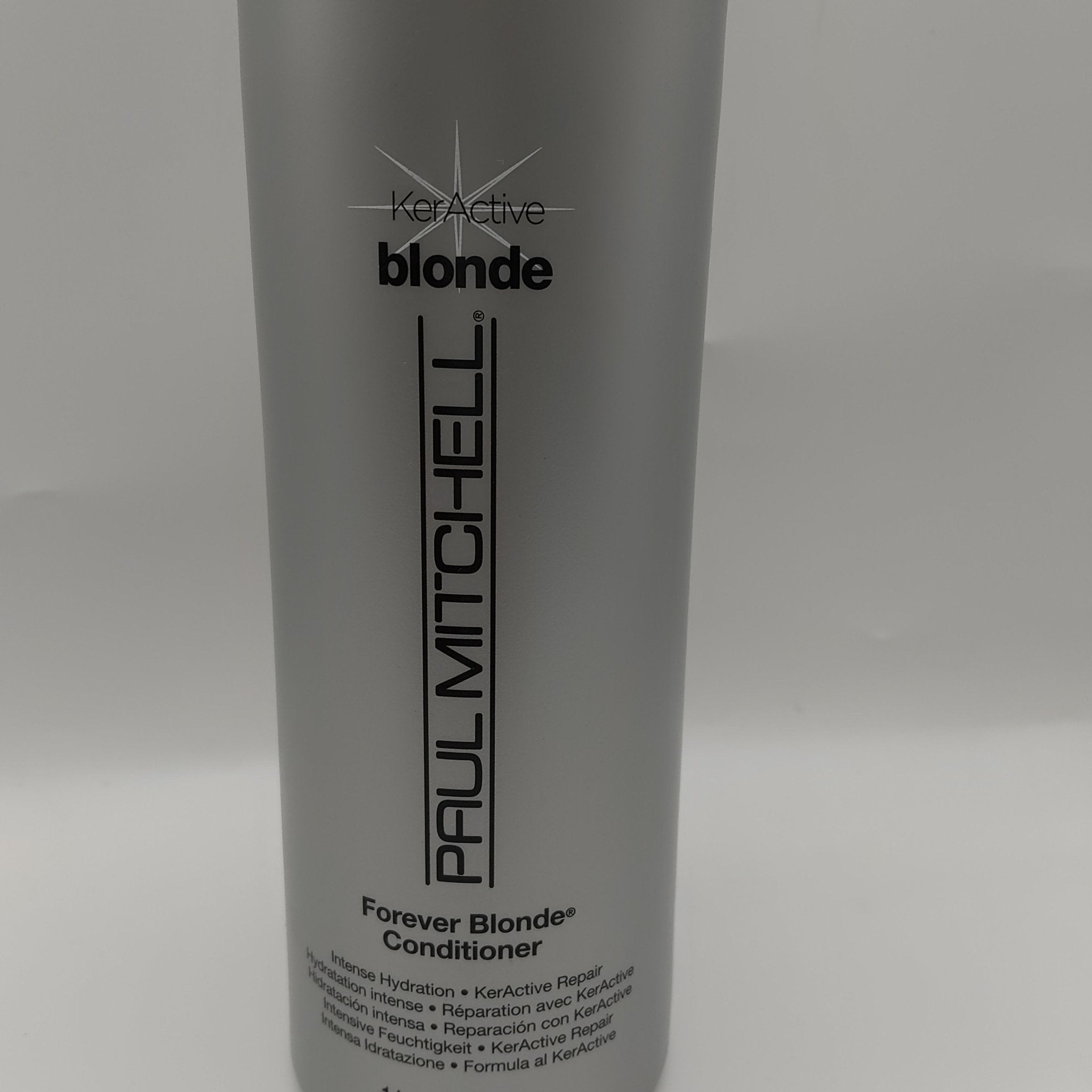Large bottle of Paul Mitchell Forever Blonde Conditioner for professional hair repair.