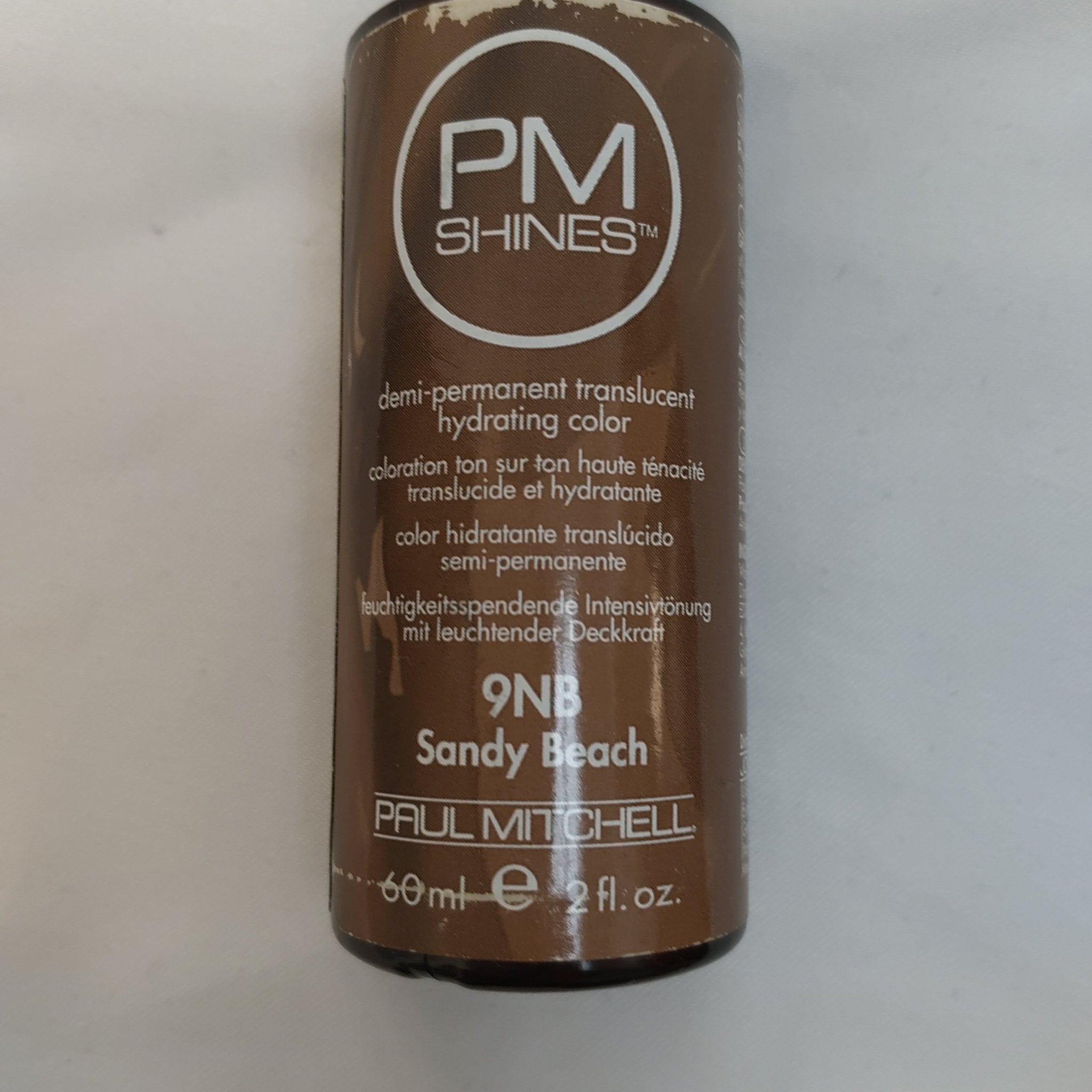 Bottle of Paul Mitchell PM Shines Demi-Permanent Hair Color in 9NB Sandy Beach