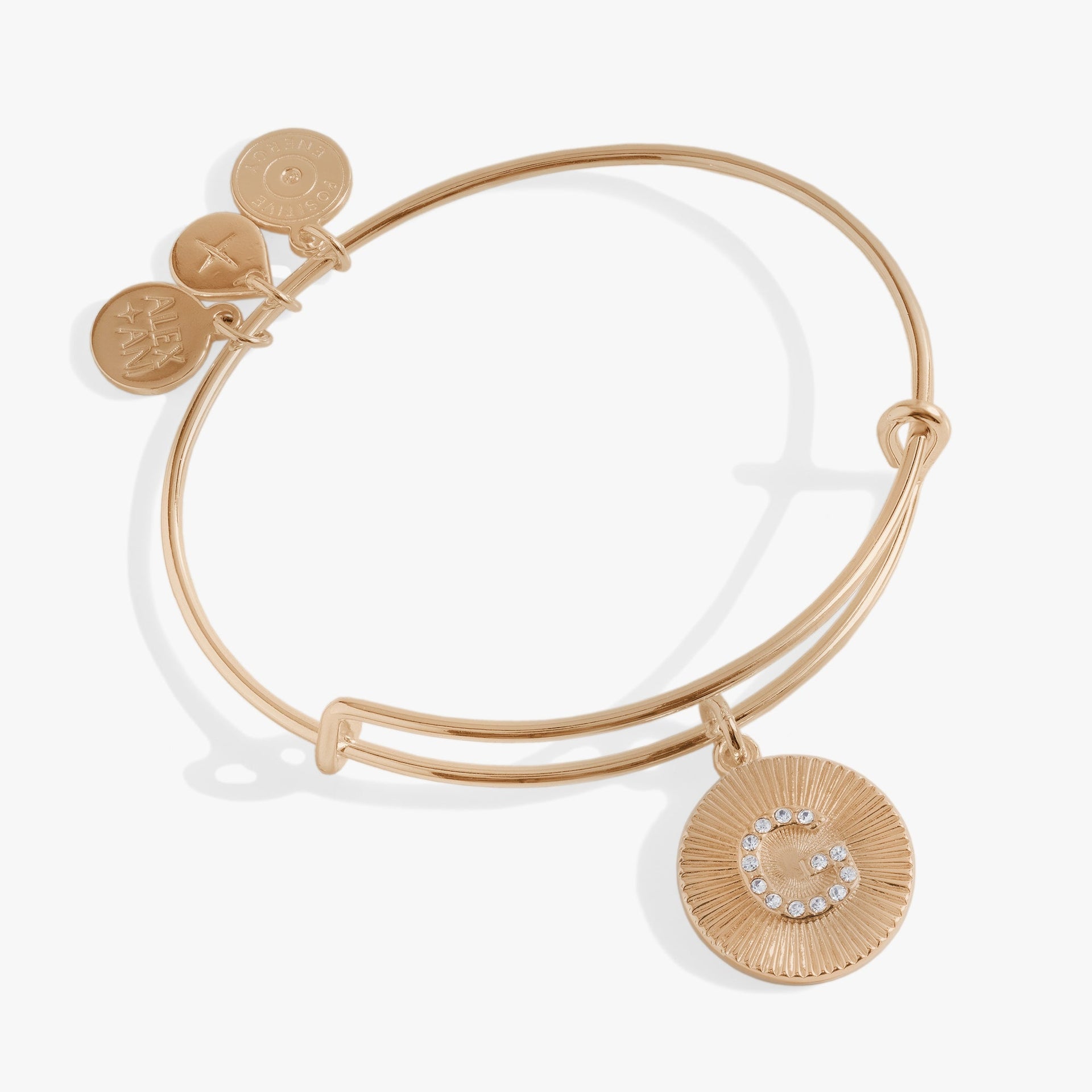 Alex and Ani Initial G Bangle with pavé crystal starburst charm on a white background