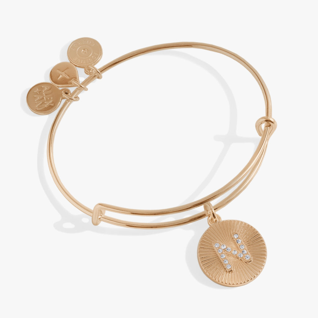 Gold and silver starburst texture bangle featuring the letter N in pavé crystals