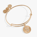 Pavé crystal initial S charm on a starburst textured bangle bracelet.