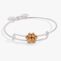 Silver-plated bangle with a gold-plated paw print slider bead and a clear crystal accent.