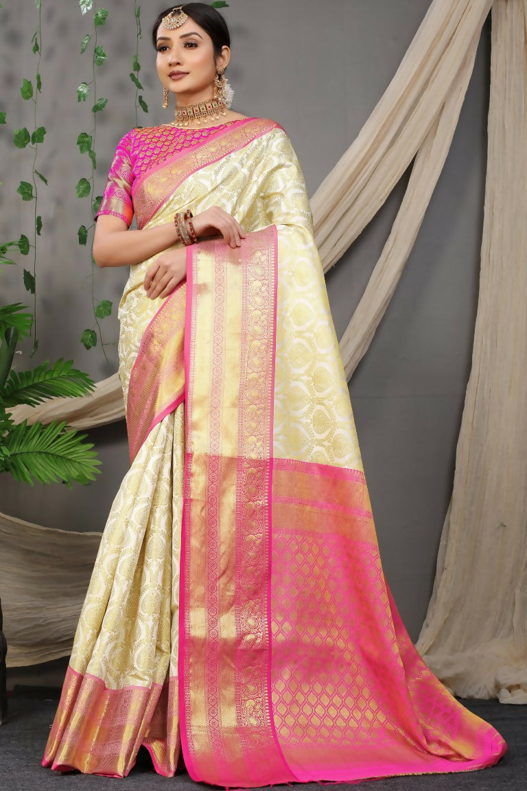 Off white Kanjivaram silk saree featuring zari work and a contrasting pink blouse piece.
