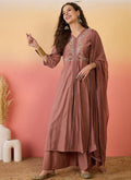 Woman wearing a brown A-line Roman Silk kurta with matching palazzo pants and embroidered details.