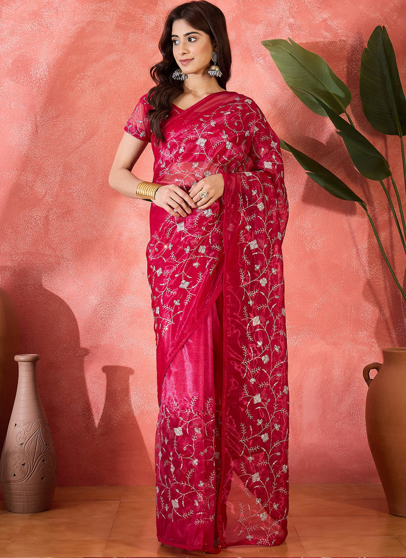 A vibrant red organza saree with intricate sequence embroidery and a matching blouse.