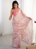 Baby girl wearing a pink Chinon printed party wear saree with unstitched blouse
