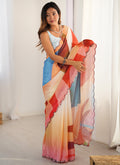 Close-up of a multi-color geometric print saree with orange, blue, pink, and cream accents