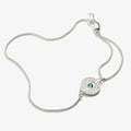 Close up of an evil eye charm bracelet with clear crystals on an adjustable pull chain.