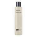 Neutral beige bottle of PCA Skin facial wash with black text branding.