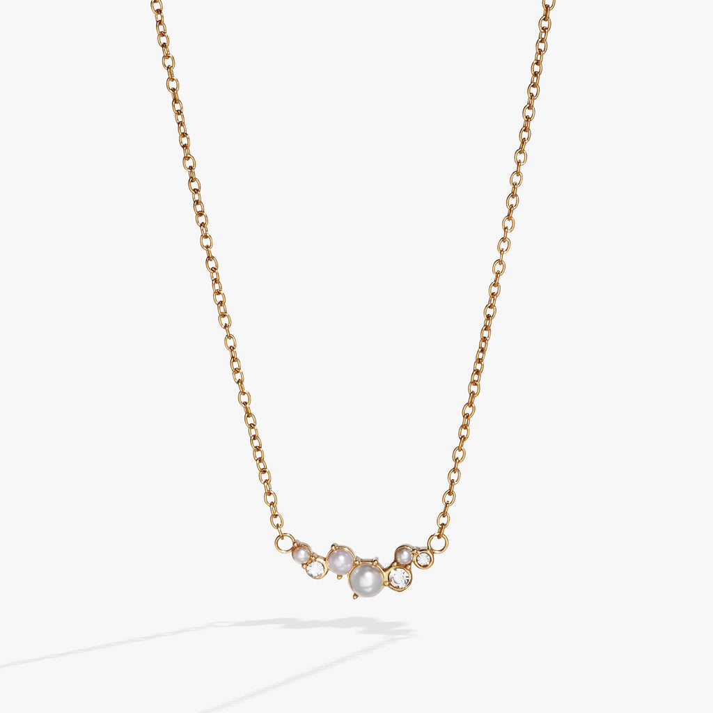 Gold-tone stainless steel inline necklace featuring pearl glass beads and clear crystals