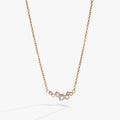Gold-tone stainless steel inline necklace featuring pearl glass beads and clear crystals