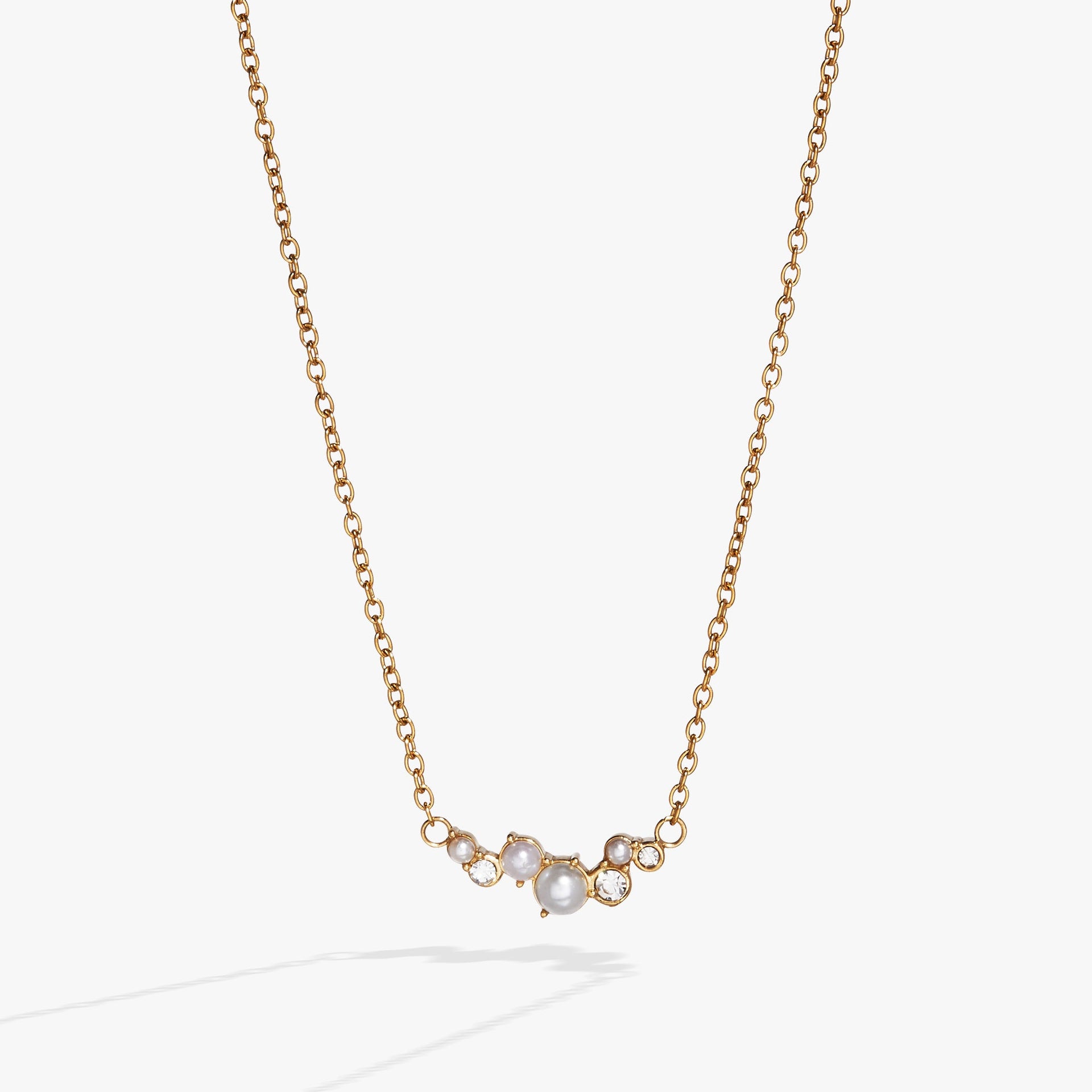 Gold-tone stainless steel inline necklace featuring pearl glass beads and clear crystals