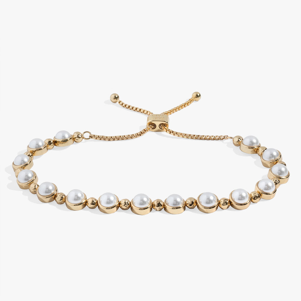 Adjustable pearl bolo bracelet featuring glass pearls with a silver or gold slider closure.