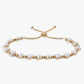 Adjustable pearl bolo bracelet featuring glass pearls with a silver or gold slider closure.