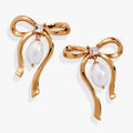 Gold-plated bow earrings with a sparkling crystal center and a dangling white pearl drop.
