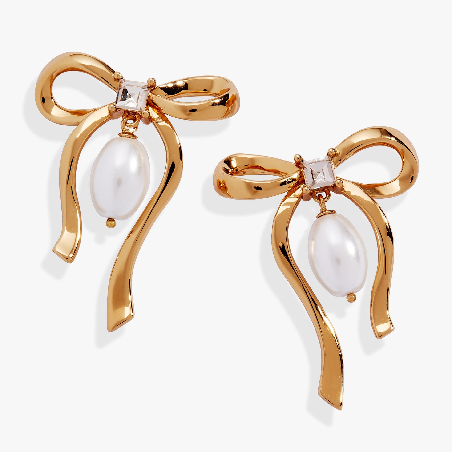 Gold-plated bow earrings with a sparkling crystal center and a dangling white pearl drop.