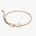 Gold-plated dove charm bracelet with white mother-of-pearl inlay on an adjustable pull chain.