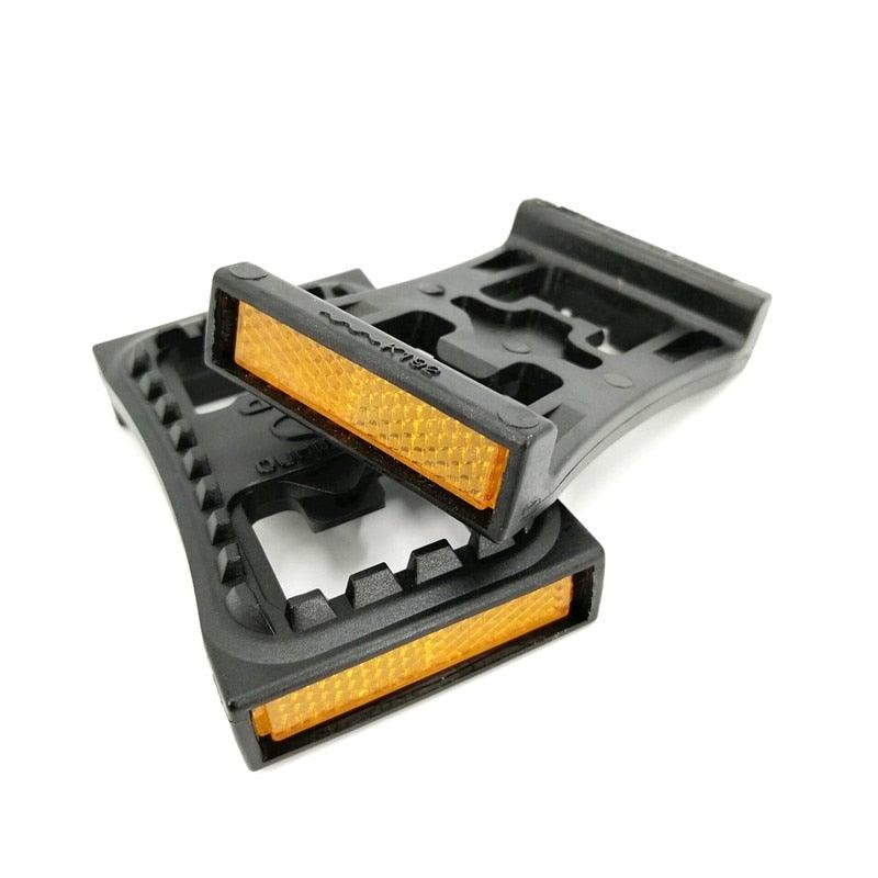 Universal bike pedal adapter converting clipless pedals to a flat platform surface for casual footwear.