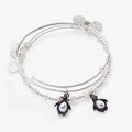Set of two silver-tone bangles featuring enamel and pearl crystal penguin charms with accent beads.