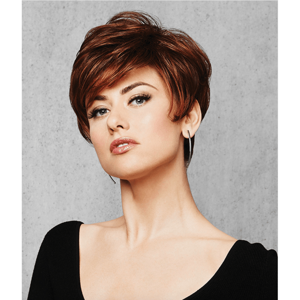 A stylish woman wearing the Perfect Pixie Wig in a rich auburn shade with textured layers.