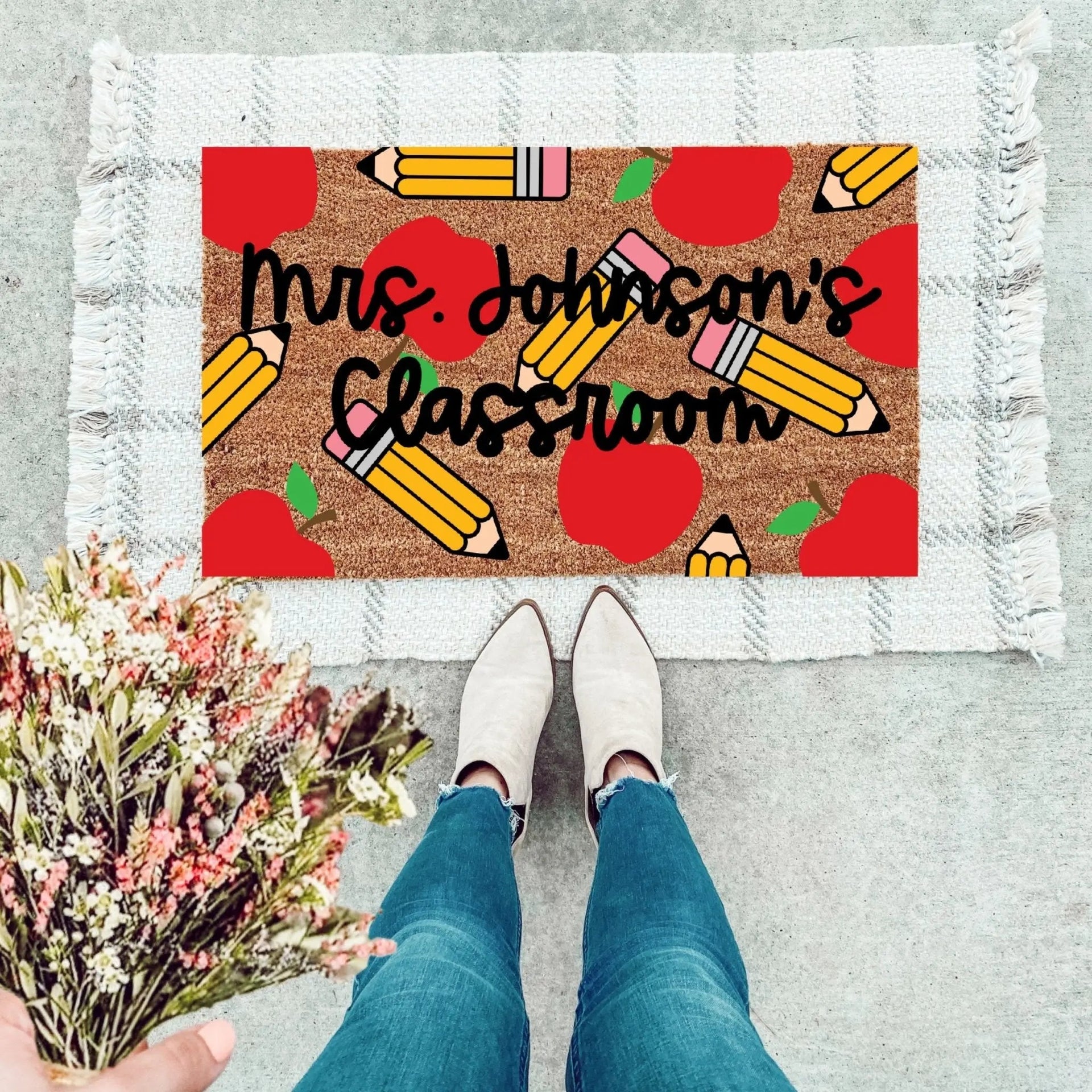 Personalized teacher doormat with custom last name text.