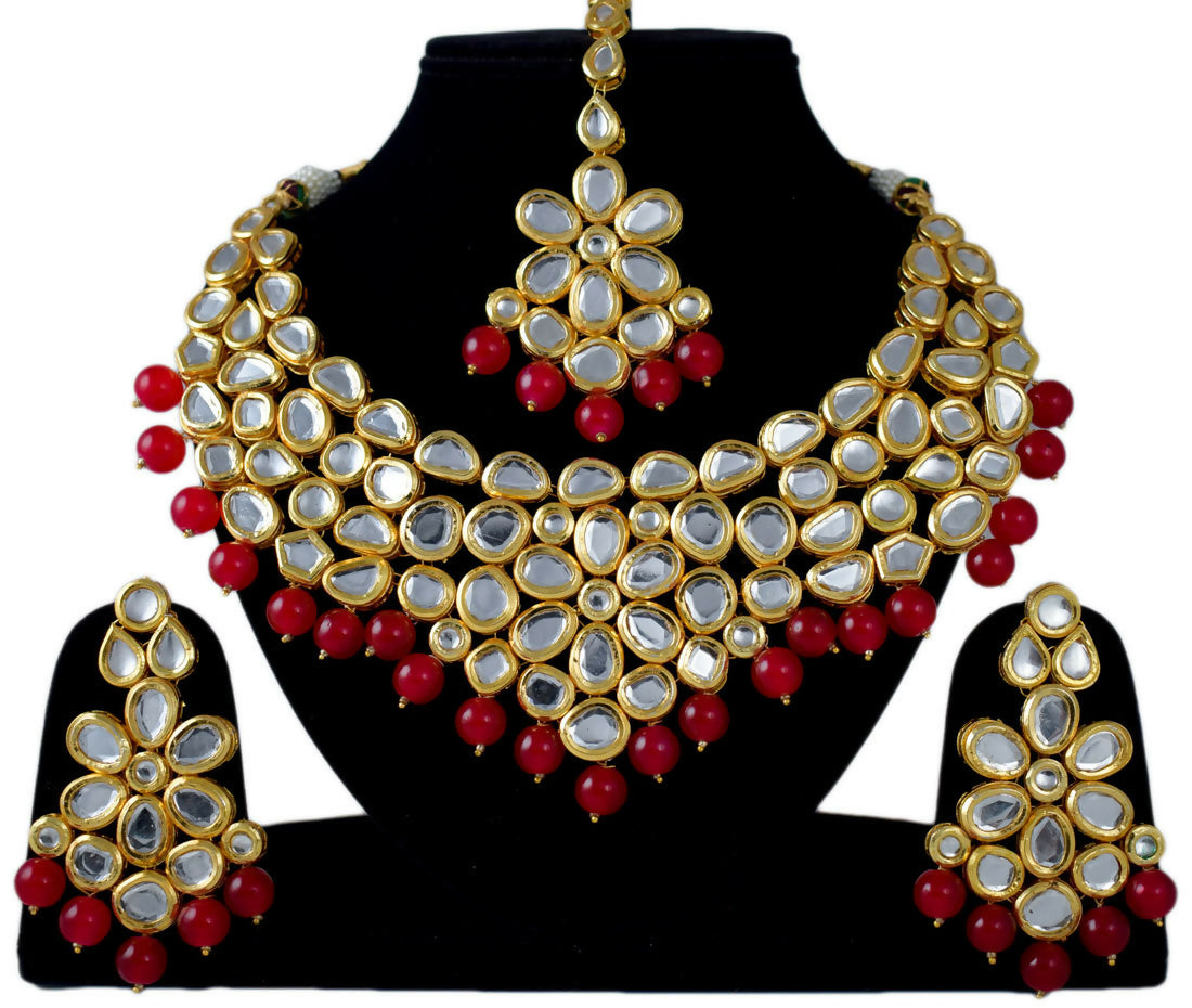 Elegant gold plated Kundan jewellery set featuring hand-studded stone design