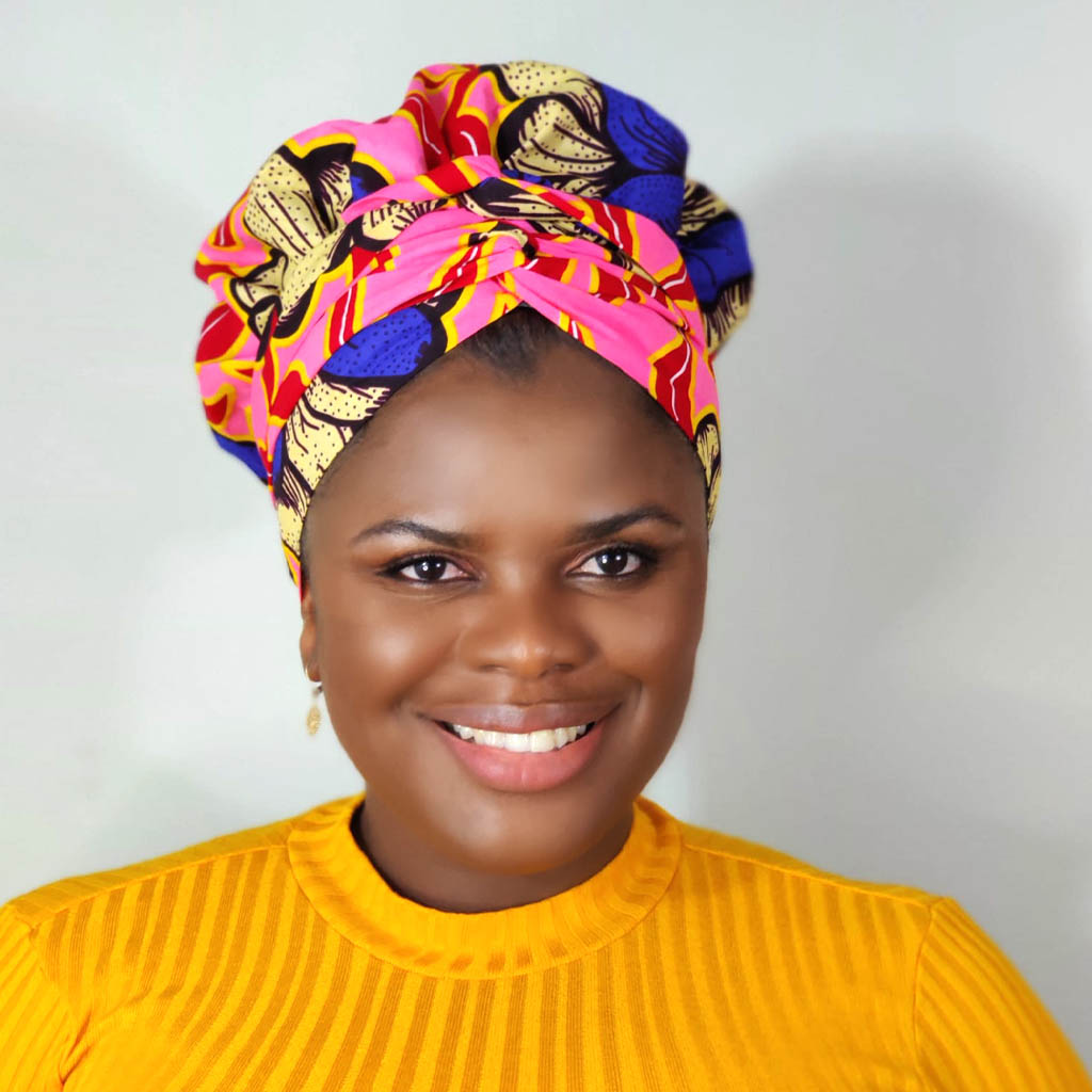 Model wearing a vibrant Kente African print bonnet wrap with long tie straps