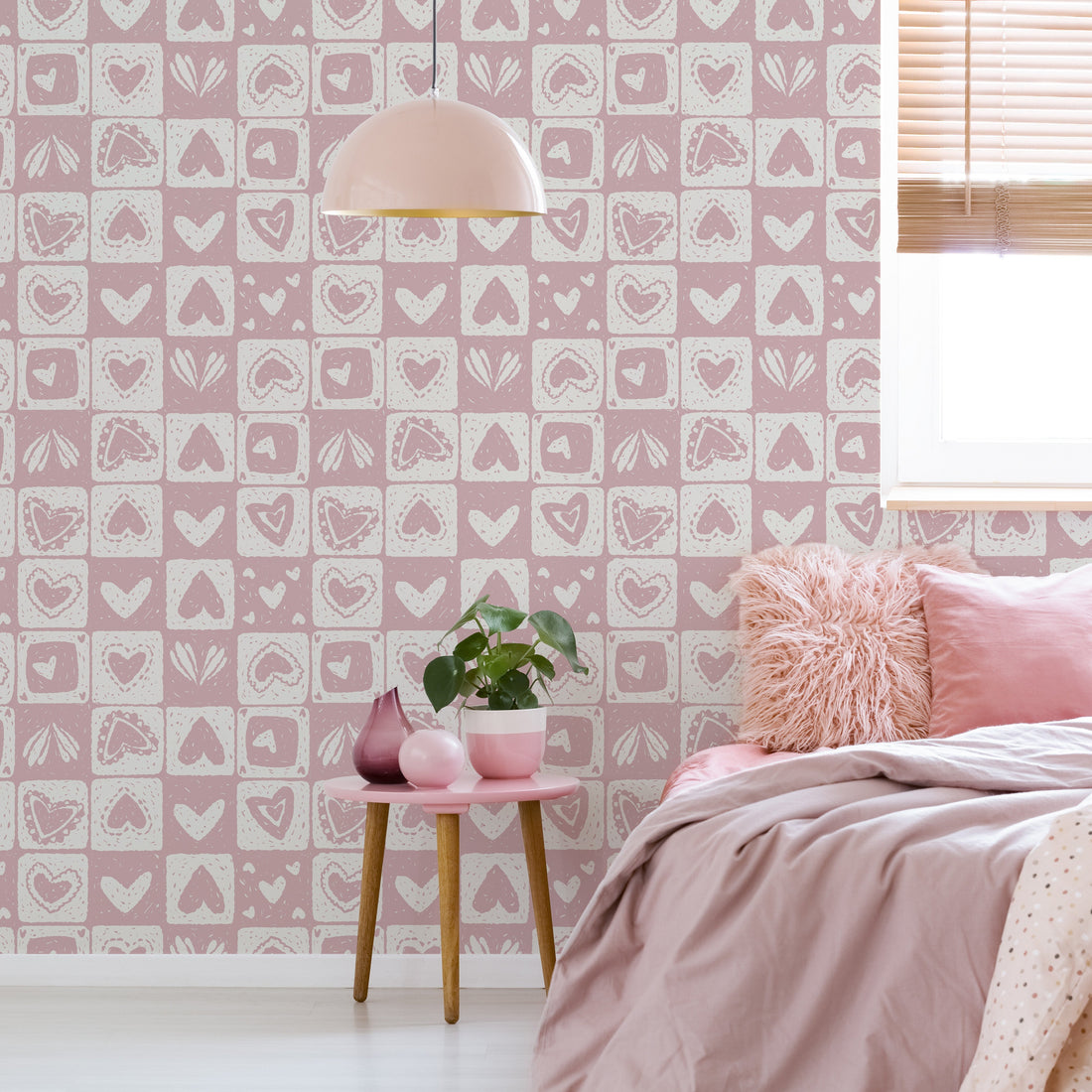 Haisley geometric patterned wallpaper in soft pink and white.