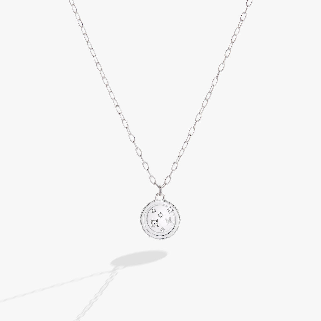 Double-sided Pisces zodiac pendant necklace with crystal accents on a delicate chain